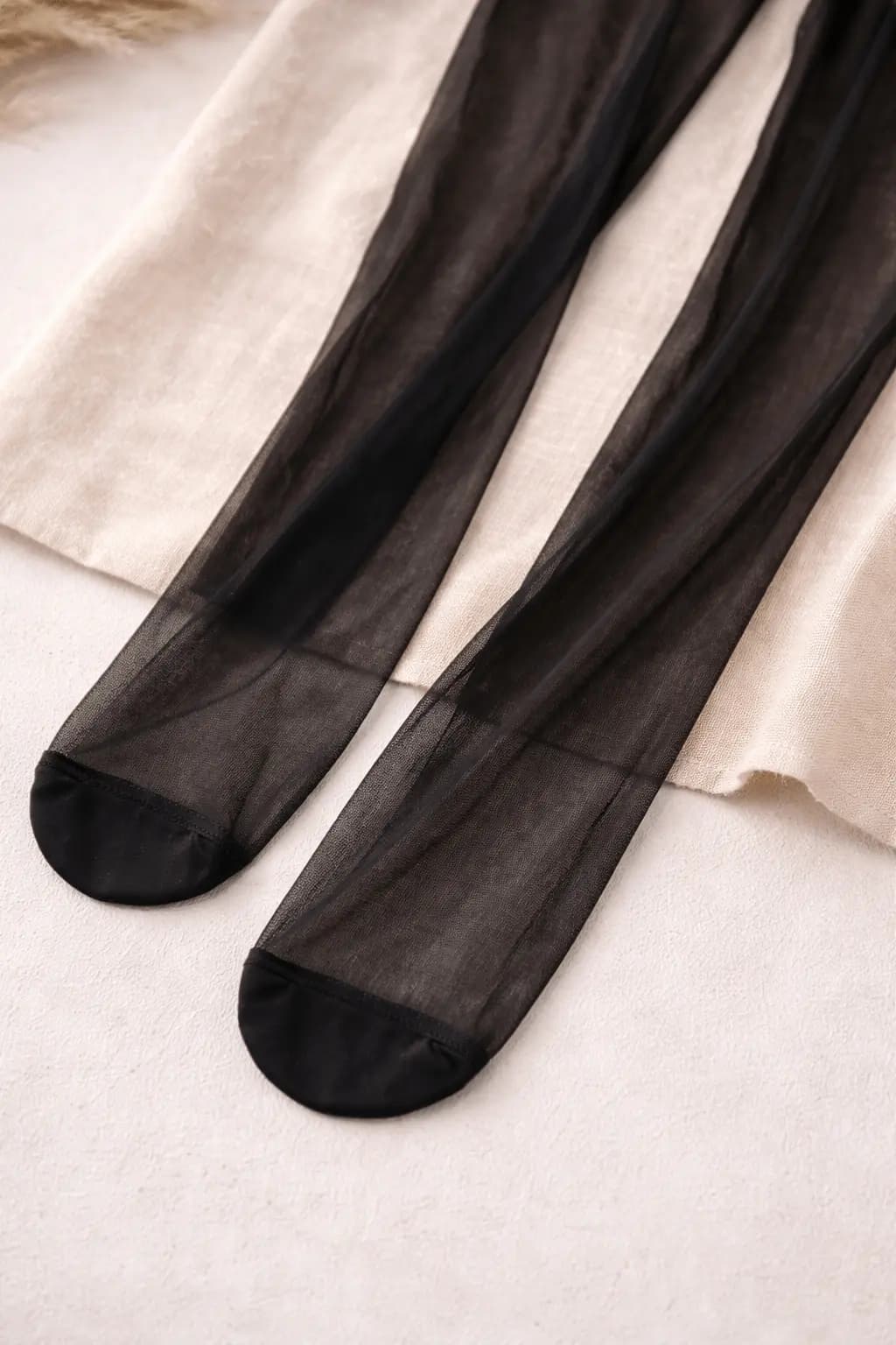 Gravid person i klänning med bekväma strumpbyxor i varm hemmamiljö.